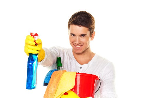Worker managing a safe carpet cleaning area with caution signs