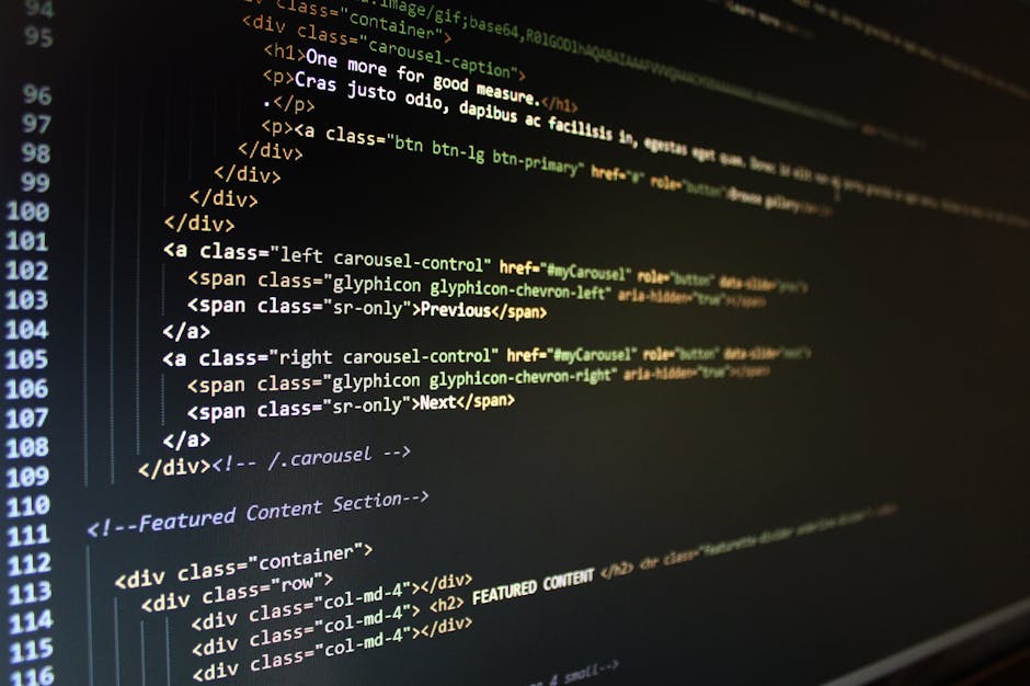 Close-up of a computer screen displaying HTML code with lines of tags and scripts in various colors, indicating web development or coding activities. The focus is on the illuminated text against a dar